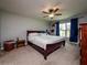 Main bedroom with a double bed and large window at 1436 Ne 161St Pl, Citra, FL 32113