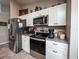 Modern kitchen with stainless steel appliances and white cabinets at 1436 Ne 161St Pl, Citra, FL 32113