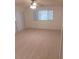 Living area with light wood flooring and large windows at 10886 Sw 87Th Ct, Ocala, FL 34481