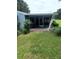 Side view of a screened porch with a paved patio at 10886 Sw 87Th Ct, Ocala, FL 34481