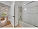 Bathroom with a shower/tub combo and view into bedroom at 4897 Cypress Woods Dr # 6313, Orlando, FL 32811