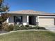 One-story house featuring a neutral color palette and neatly landscaped front yard at 8719 Sw 76Th Street Rd, Ocala, FL 34481