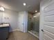 Modern bathroom with gray vanity and large shower at 13 Ash Rd, Ocala, FL 34472