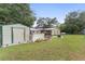 Landscaped backyard with shed and fence at 20925 River Dr, Dunnellon, FL 34431