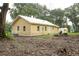 Yellow house with metal roof and shed at 1750 Ne 180Th St, Citra, FL 32113