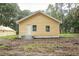 Rear view of a yellow house with metal roof and small steps at 1750 Ne 180Th St, Citra, FL 32113