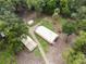 Aerial view of yellow house with detached garage and shed at 1750 Ne 180Th St, Citra, FL 32113