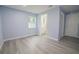 Spacious bedroom with gray vinyl flooring and an ensuite bathroom at 1750 Ne 180Th St, Citra, FL 32113