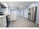 Modern kitchen with stainless steel appliances and light gray vinyl flooring at 1750 Ne 180Th St, Citra, FL 32113