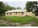 Yellow house with metal roof and detached garage at 1750 Ne 180Th St, Citra, FL 32113
