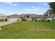 Single-story home with a two-car garage and well-maintained lawn at 5851 Sw 86Th Pl, Ocala, FL 34476