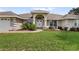 Landscaped yard and entrance to a single-story home at 5851 Sw 86Th Pl, Ocala, FL 34476