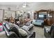 Open-concept living room with leather sofas and a large TV at 5851 Sw 86Th Pl, Ocala, FL 34476