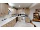 Bright kitchen with white appliances and wood cabinets at 8420 Sw 92Nd St # B, Ocala, FL 34481