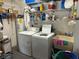 Well-equipped laundry room with washer, dryer, and ample storage shelving at 8420 Sw 92Nd St # B, Ocala, FL 34481