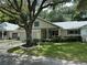 Front view of a light beige house with a covered porch and well-maintained landscaping at 8420 Sw 92Nd St # B, Ocala, FL 34481