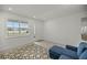 Bright entryway with a blue sofa and patterned rug at 7288 Sw 64Th Street Rd, Ocala, FL 34474