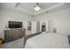 Main bedroom with a large bed and access to en-suite bathroom at 7288 Sw 64Th Street Rd, Ocala, FL 34474