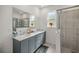 Bathroom boasts double vanity, a large mirror, and a walk-in shower at 7288 Sw 64Th Street Rd, Ocala, FL 34474