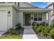 Inviting front porch of a one-story home with landscaping at 7288 Sw 64Th Street Rd, Ocala, FL 34474
