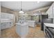 A large kitchen island with white cabinets and a quartz countertop at 1989 Nw 111Th Loop, Ocala, FL 34475
