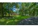 House with stone exterior surrounded by mature trees at 1989 Nw 111Th Loop, Ocala, FL 34475