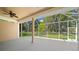 Spacious screened-in porch with tranquil views of the backyard at 1989 Nw 111Th Loop, Ocala, FL 34475