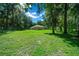Large backyard with mature trees and lush green grass at 1989 Nw 111Th Loop, Ocala, FL 34475
