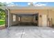 Exterior view of garage with open door, stone accents, and lanterns at 1989 Nw 111Th Loop, Ocala, FL 34475