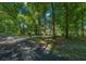 House driveway surrounded by lush green trees at 1989 Nw 111Th Loop, Ocala, FL 34475