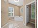Bathroom features corner tub, tile flooring and window at 1989 Nw 111Th Loop, Ocala, FL 34475