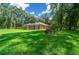 View of house backyard with screened patio and lush grass at 1989 Nw 111Th Loop, Ocala, FL 34475