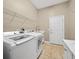 Bright laundry room with washer, dryer, and built-in sink at 1989 Nw 111Th Loop, Ocala, FL 34475