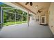 Spacious screened-in porch with a view of a large backyard and trees at 1989 Nw 111Th Loop, Ocala, FL 34475