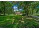 Stone house nestled among tall trees on a large lot at 1989 Nw 111Th Loop, Ocala, FL 34475