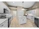 Bright kitchen, white cabinets, quartz countertops, and an island at 1989 Nw 111Th Loop, Ocala, FL 34475