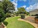 Landscaped backyard with lush lawn, stone pathway, and mature trees at 16376 Sw 13Th Ter, Ocala, FL 34473