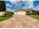 Two-story house with a two-car garage and a stone driveway at 16376 Sw 13Th Ter, Ocala, FL 34473