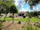 Landscaped backyard with grassy lawn, stone border, and patio at 16376 Sw 13Th Ter, Ocala, FL 34473