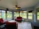 Relaxing sunroom with tiled floor, wicker furniture, and view of backyard at 16376 Sw 13Th Ter, Ocala, FL 34473