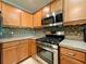 Well-equipped kitchen with stainless steel appliances and tile backsplash at 16376 Sw 13Th Ter, Ocala, FL 34473