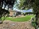 Landscaped backyard with lush lawn, stone pathway, and mature trees at 16376 Sw 13Th Ter, Ocala, FL 34473