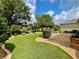 Landscaped backyard with lush lawn, stone pathway, and mature trees at 16376 Sw 13Th Ter, Ocala, FL 34473