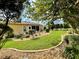 Landscaped backyard with lush lawn, stone pathway, and mature trees at 16376 Sw 13Th Ter, Ocala, FL 34473