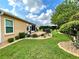 Landscaped backyard with lush lawn, stone pathway, and mature trees at 16376 Sw 13Th Ter, Ocala, FL 34473