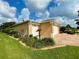 Tan house with double garage doors and landscaped yard at 16376 Sw 13Th Ter, Ocala, FL 34473