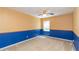 Bedroom with blue and tan walls and ceiling fan at 7545 Ne 58Th Ave, Anthony, FL 32617