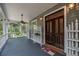 Covered front porch with ceiling fan and double doors at 7545 Ne 58Th Ave, Anthony, FL 32617
