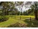 Spacious backyard with mature trees and a wooden fence at 7545 Ne 58Th Ave, Anthony, FL 32617