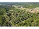 Aerial view showing home's location on a large lot in a wooded area at 7545 Ne 58Th Ave, Anthony, FL 32617